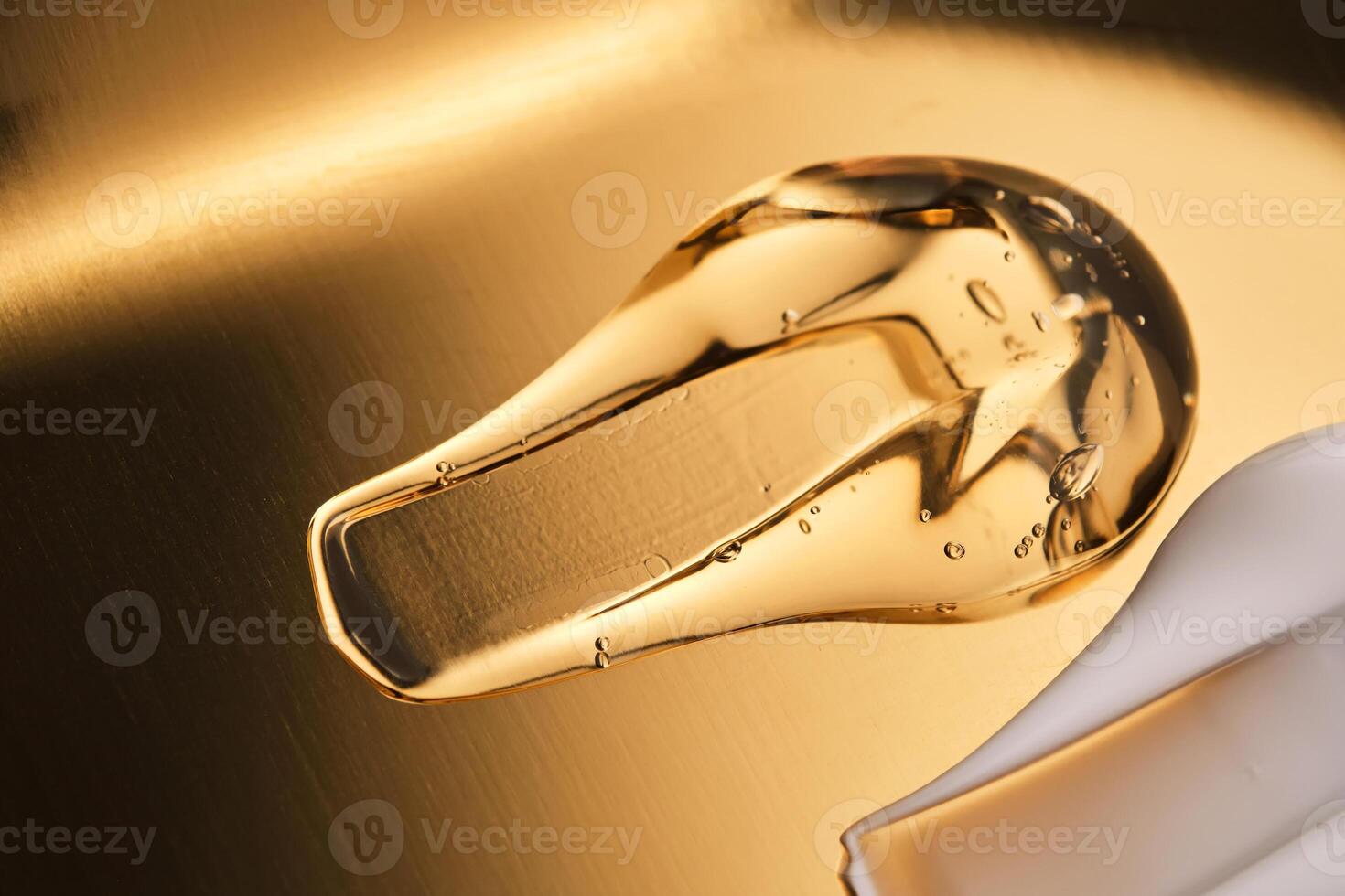 Tasty texture of cosmetic gel on a golden background. photo