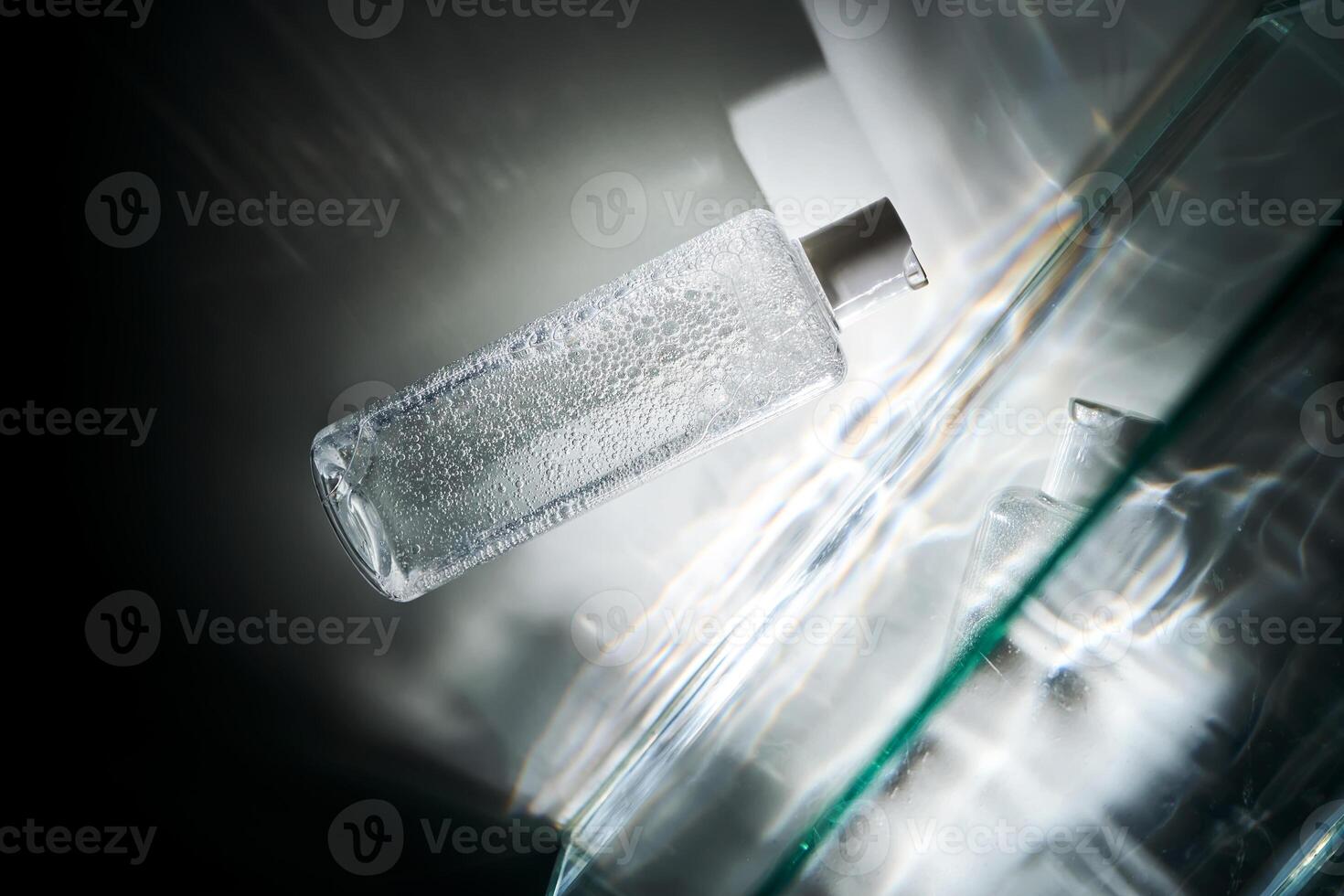 A bottle of cosmetic gel with a beautiful highlight from the water. photo