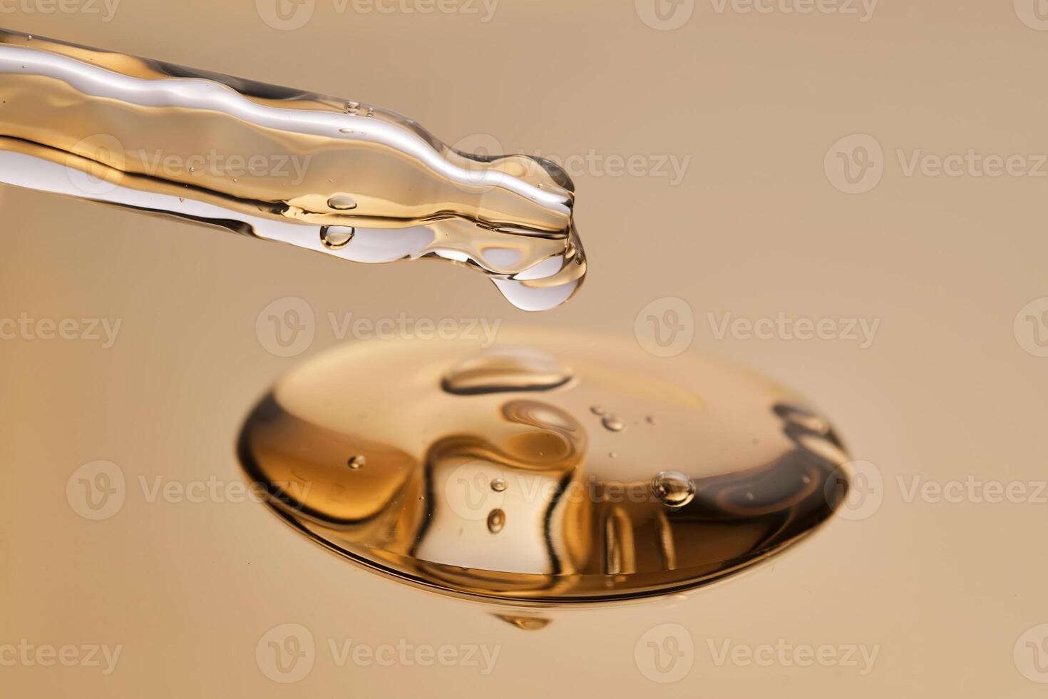 A pipette with a beautiful drop of gel-textured facial serum. photo