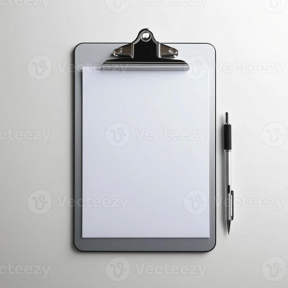 A clipboard with a pen and paper on a white surface photo