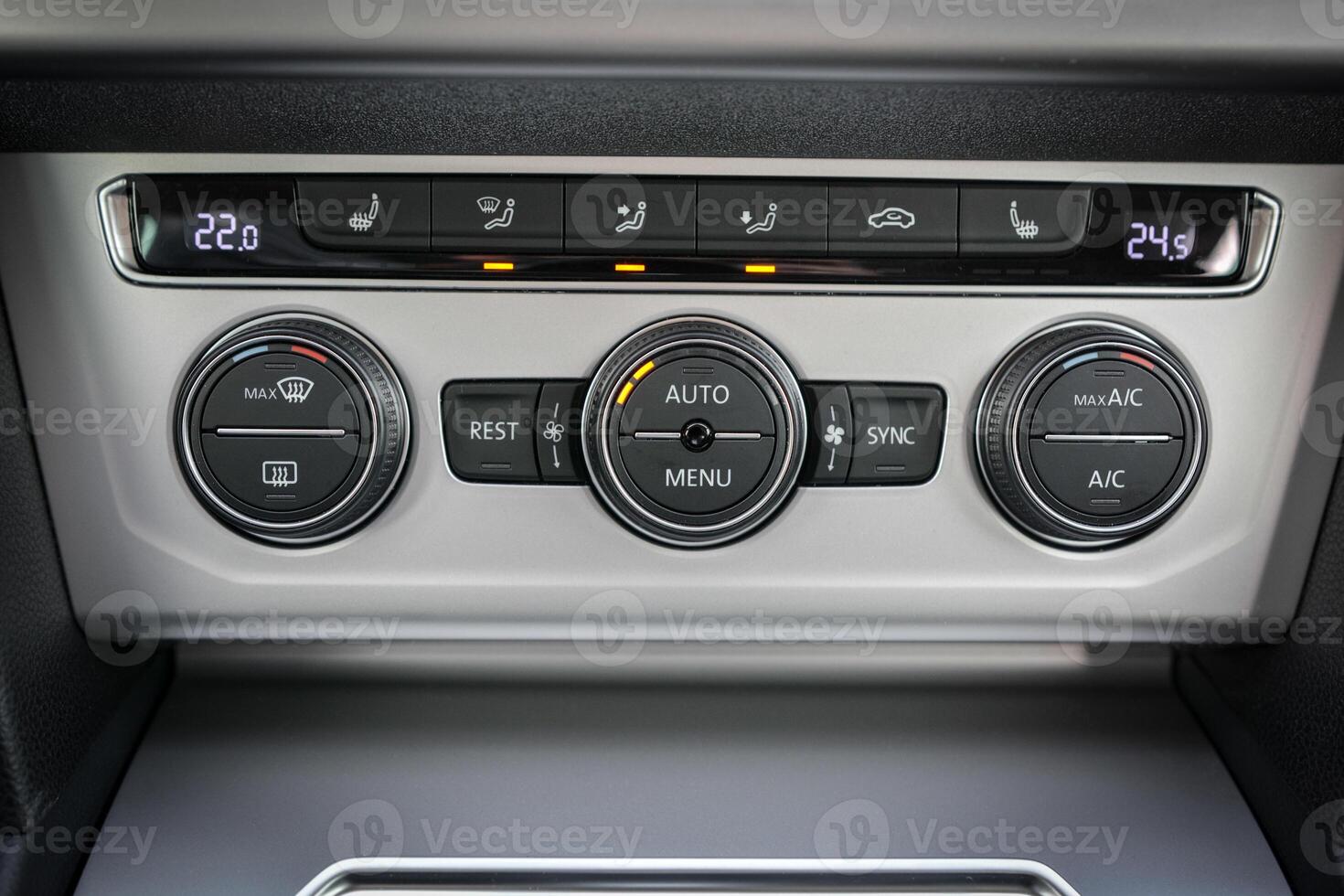 Car climate control panel with temperature display and buttons for various settings photo
