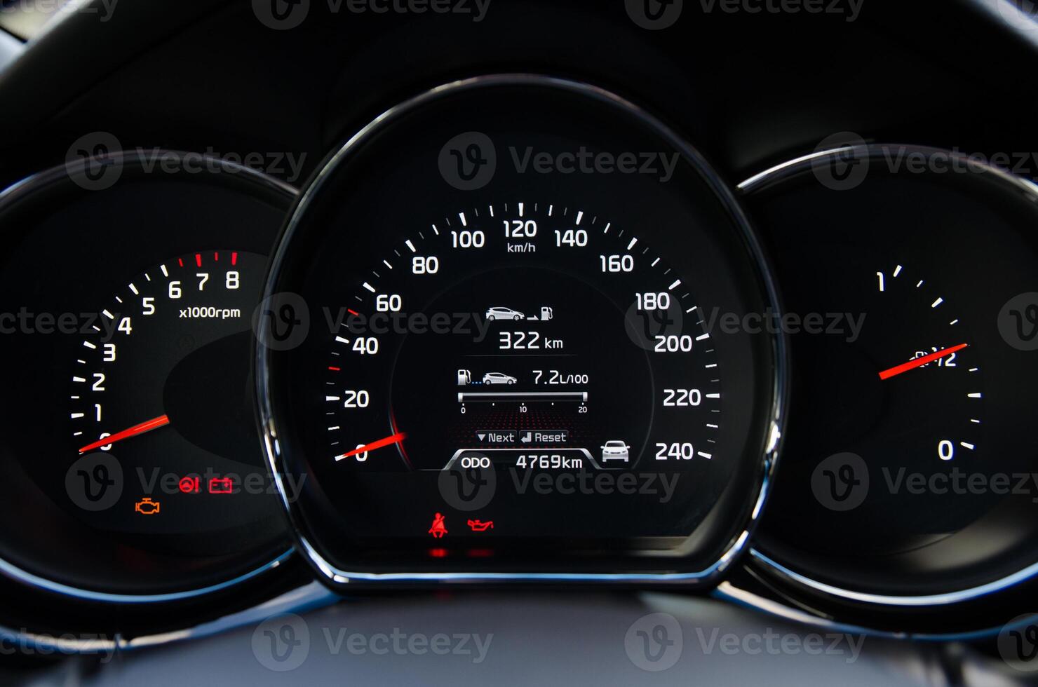Close up view of a car's instrument panel showing speedometer tachometer and fuel gauge photo