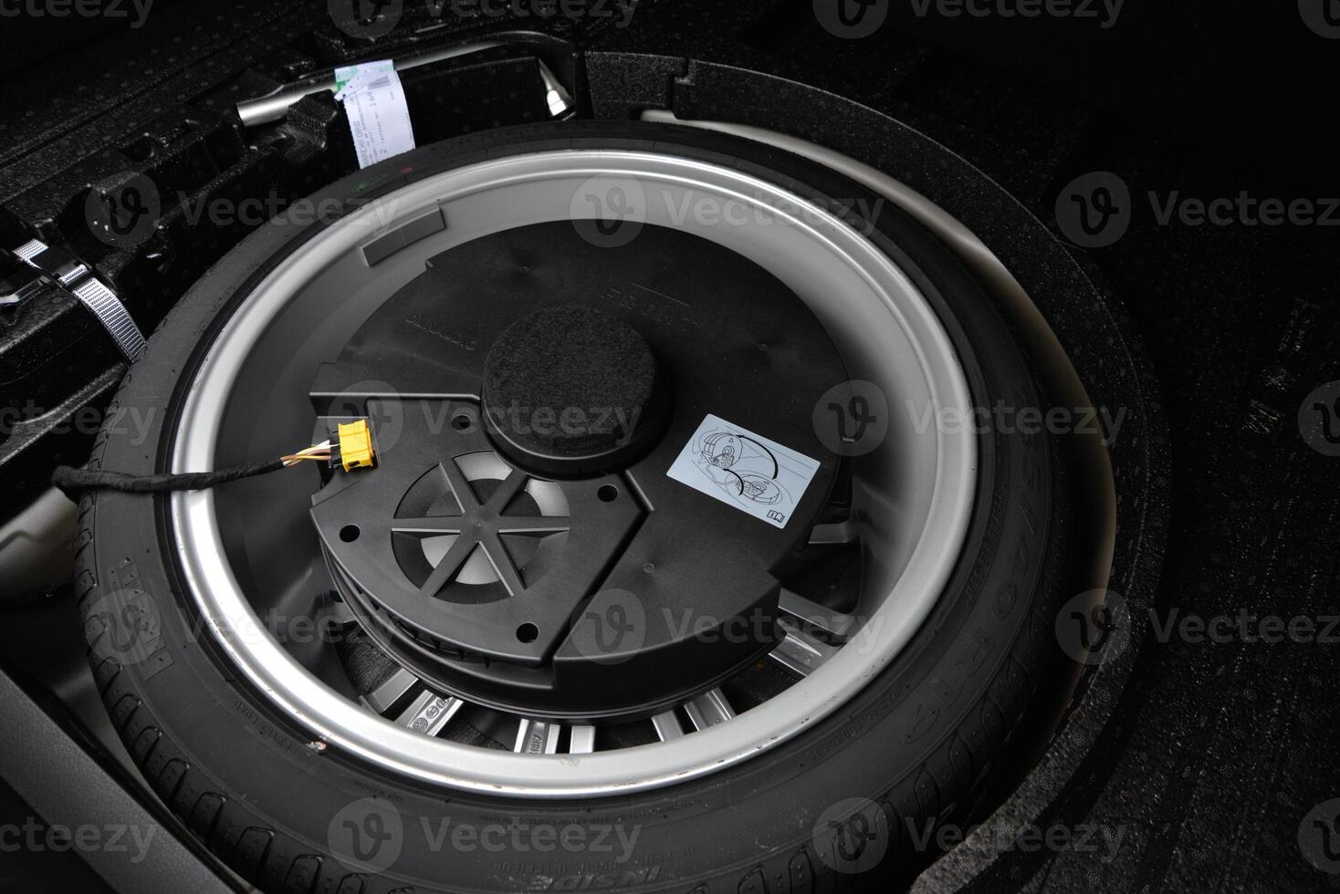 Spare tire and subwoofer in a vehicle's trunk photo