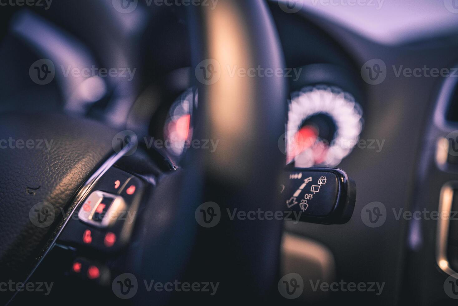 Close up of car's interior controls focusing on the steering wheel and wiper controls photo