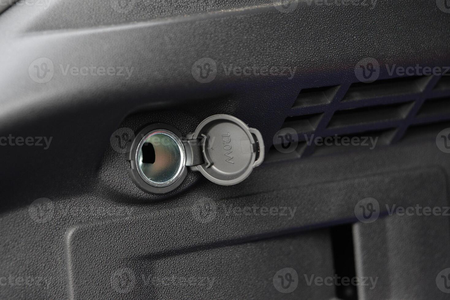 Close up of a vehicle's 12V power outlet with a protective cover photo