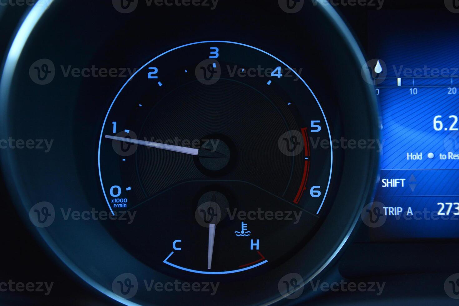 Close up of a car's instrument panel showing the tachometer speedometer and fuel gauge photo