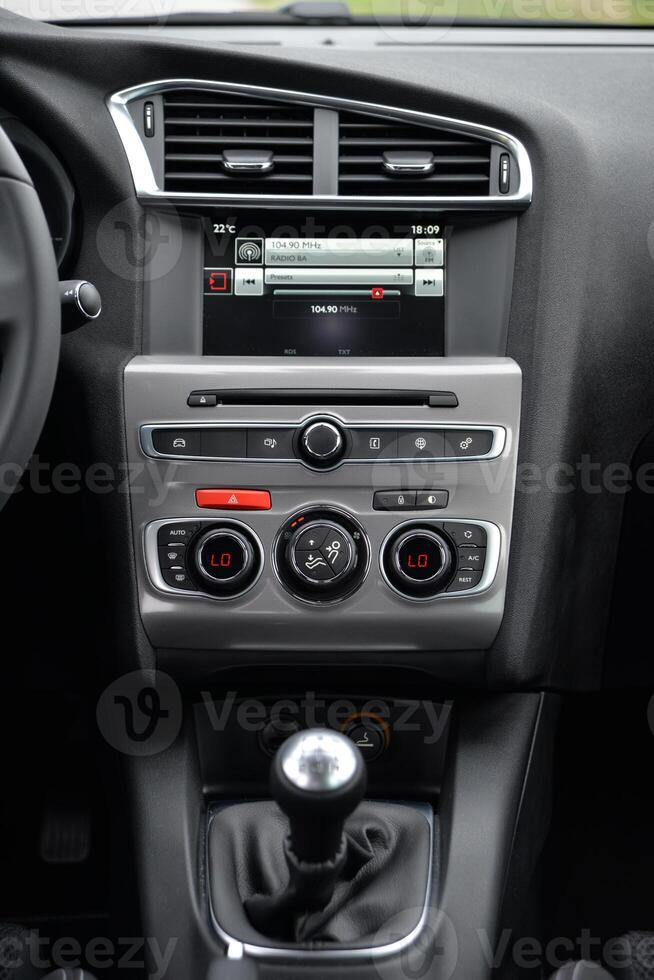 Modern car interior dashboard with digital display and climate controls photo