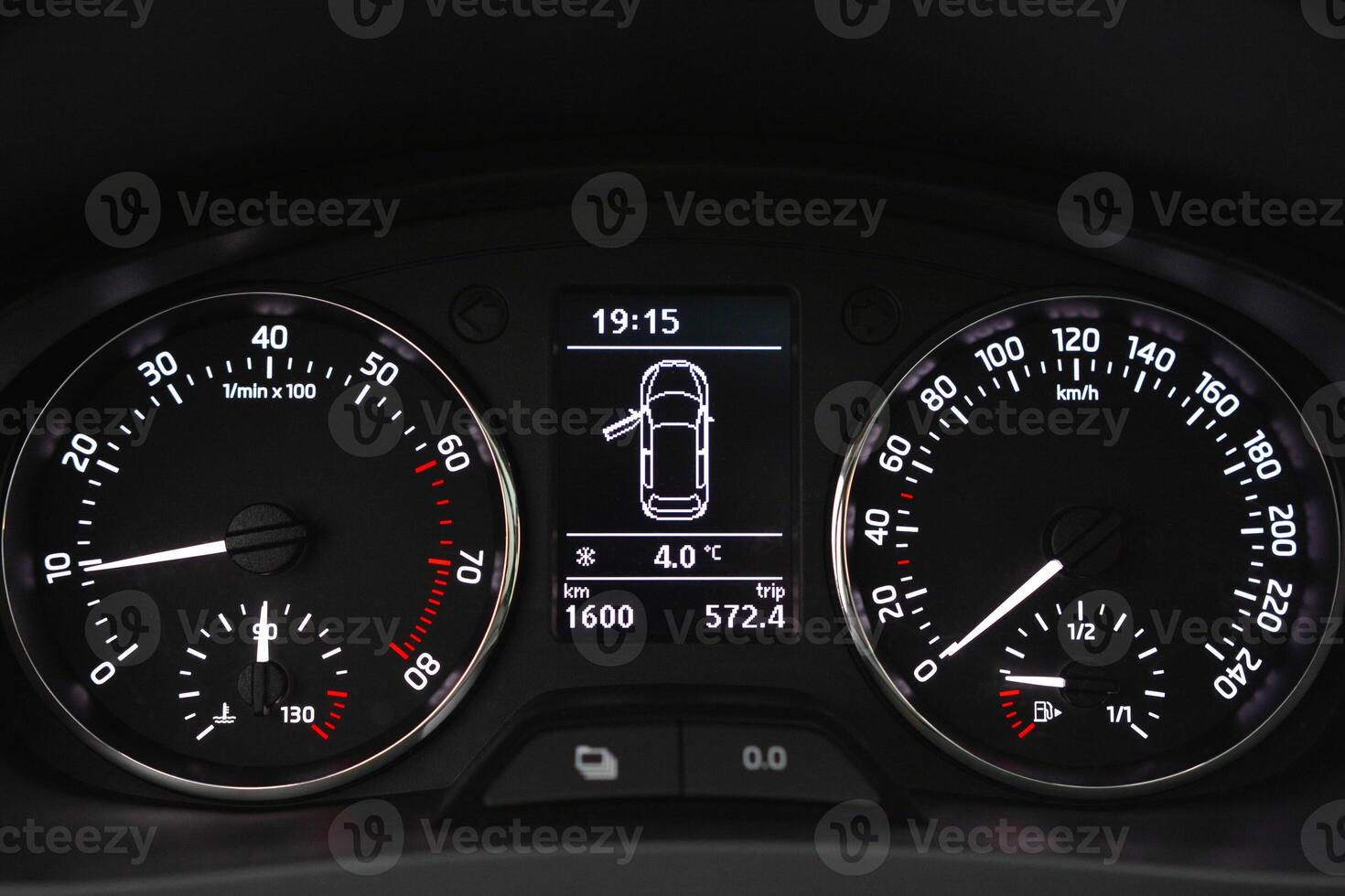 Car dashboard displaying speed RPM fuel level and time photo