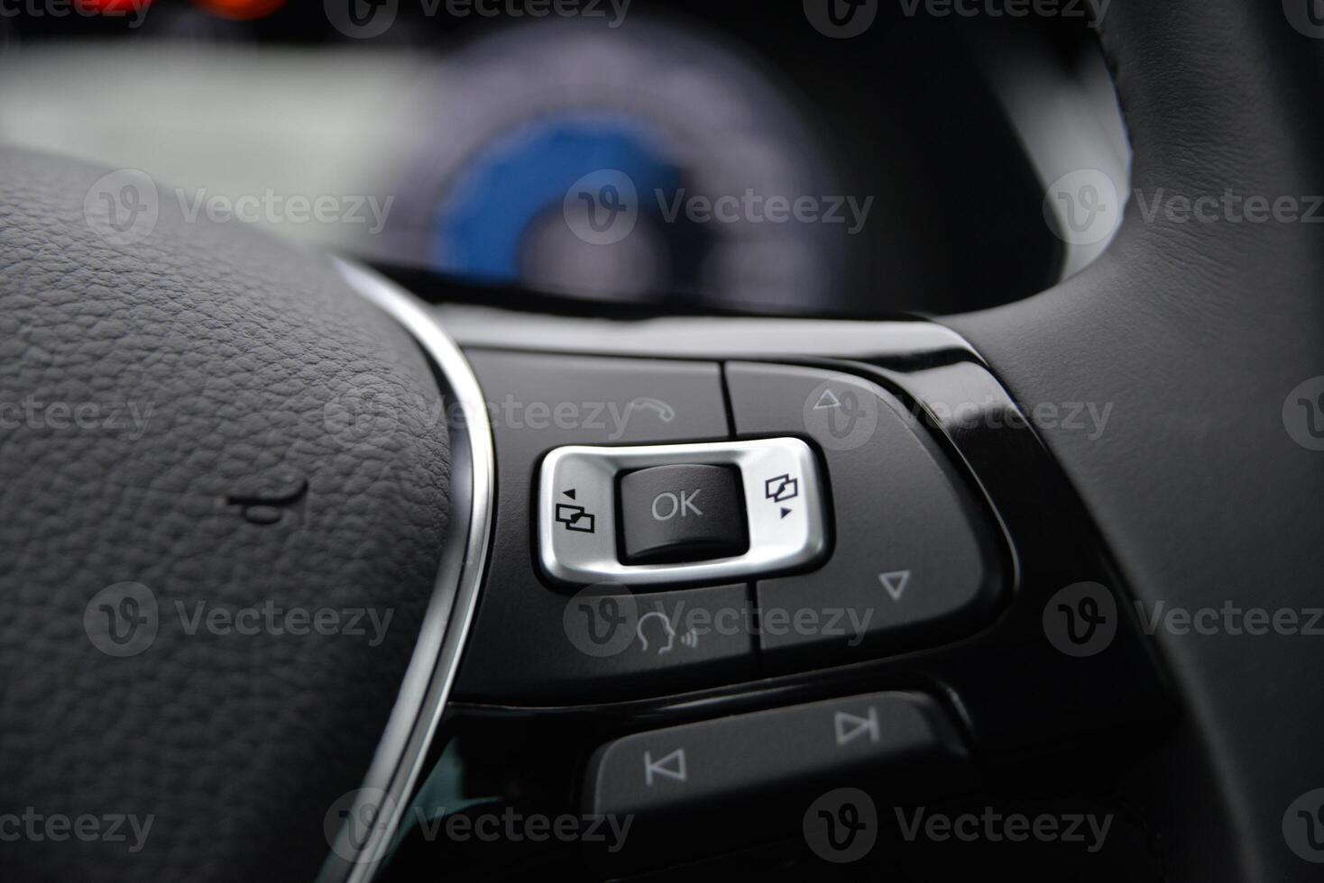 Close up of car's steering wheel controls Buttons for audio phone and vehicle functions photo