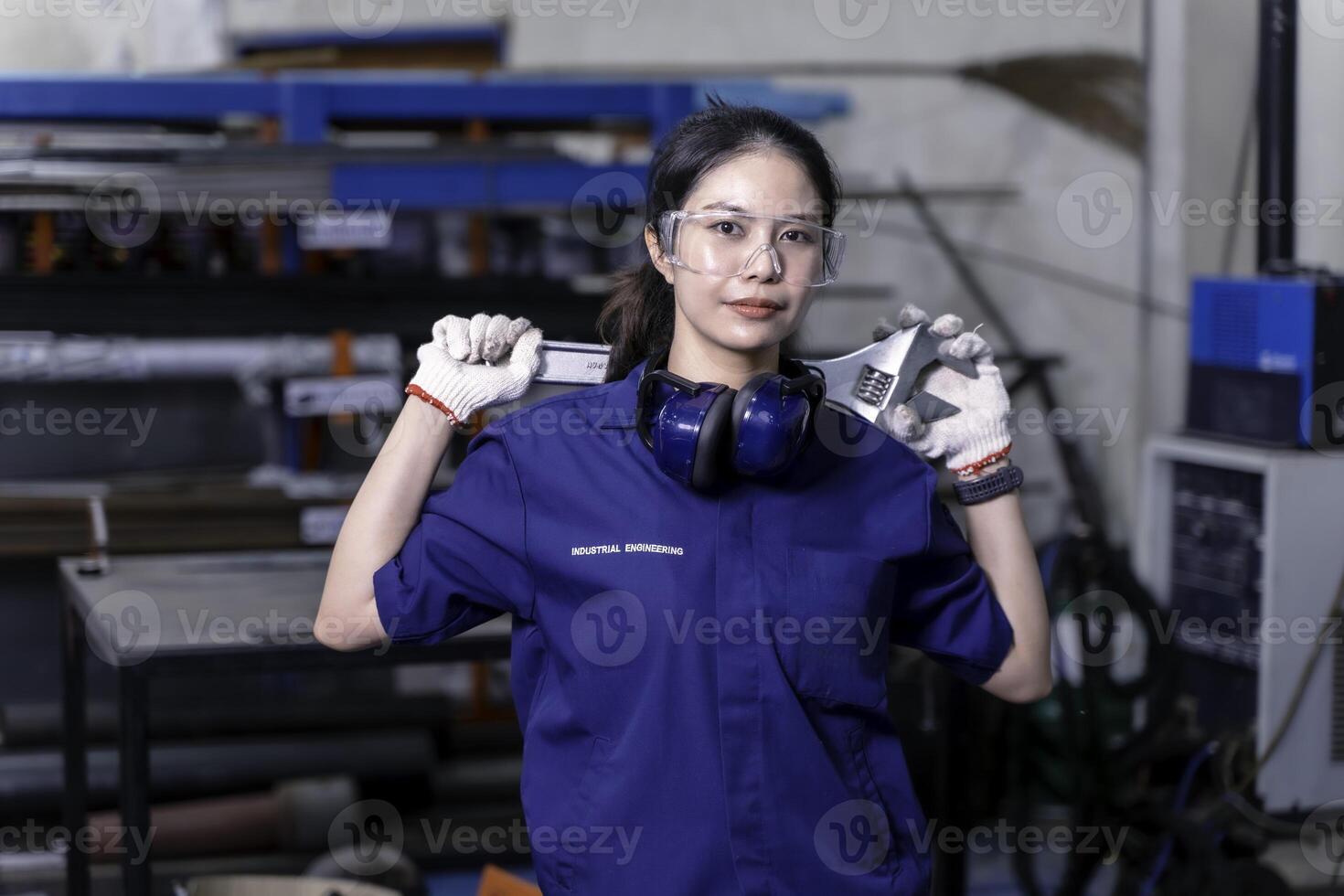 Asian woman technician engineer portrait of cheerful happy and cool action in industrial workshop. photo