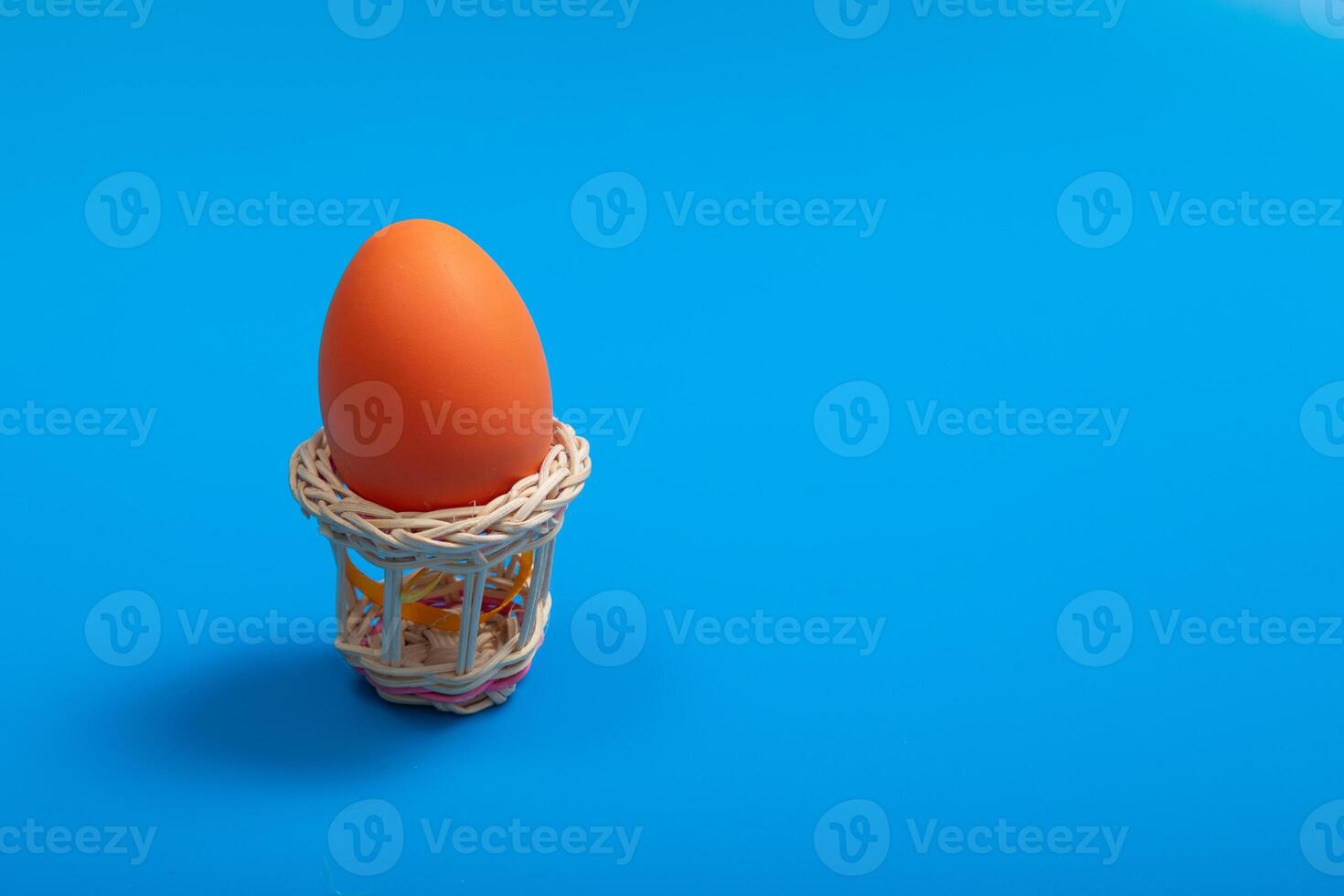 Color Eggs. Happy Easter poster, spring Christian greeting card, template sale banner, healthy menu. Bright blue color background, flat lay, copy space. Woven basket white eggs photo