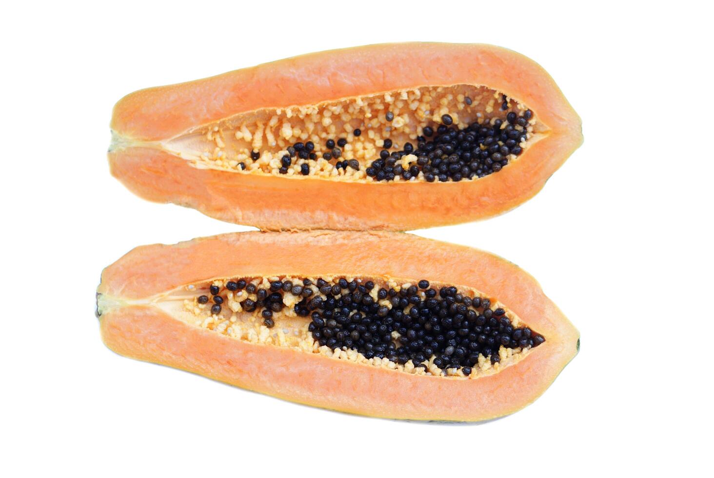 Half cut ripe papaya fruit with black seeds, isolated on white background. Concept, healthy tropical fruit with natural sweet. Delicious fruit with medicinal qualification. Good for health photo