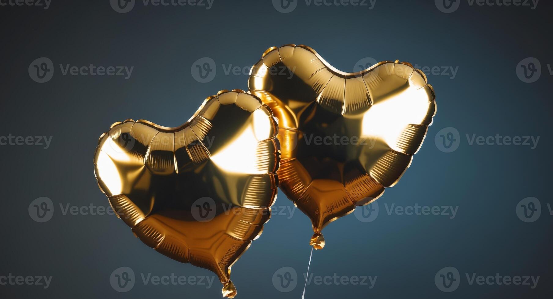 Two Shiny Gold Heart Balloons on a Dark Background for CelebrationTwo Shiny Gold Heart Balloons on a Dark Background for Celebration. photo