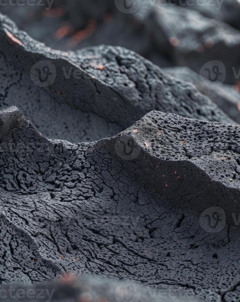 Lava rock texture featuring a porous black volcanic surface with sharp edges photo