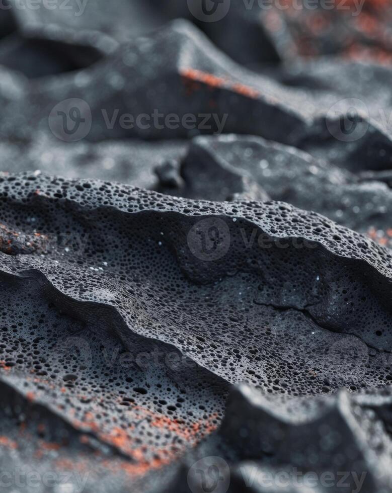 Lava rock texture featuring a porous black volcanic surface with sharp edgesLava rock texture featuring a porous black volcanic surface with sharp edges. photo