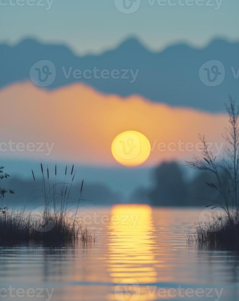 A yellow sunset over a lake with a blurred natural background of the sunset sky and lake silhouette photo