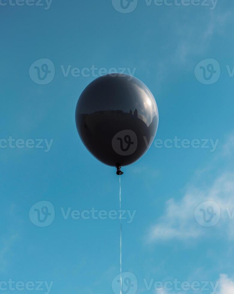 Black Balloon on Blue Background with Copy SpaceBlack Balloon on Blue Background with Copy Space. photo