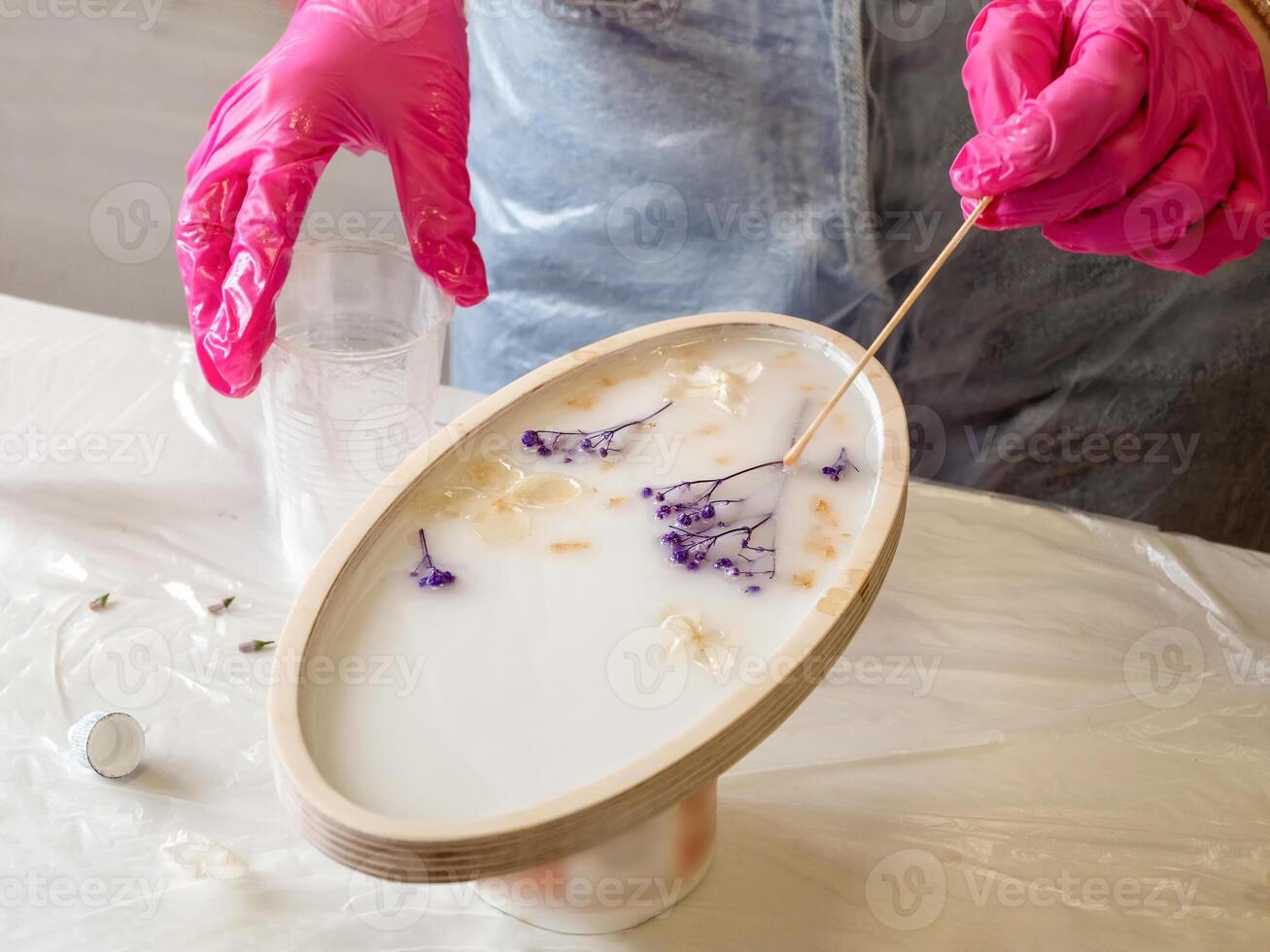art process of pouring epoxy resin into a wooden toy photo