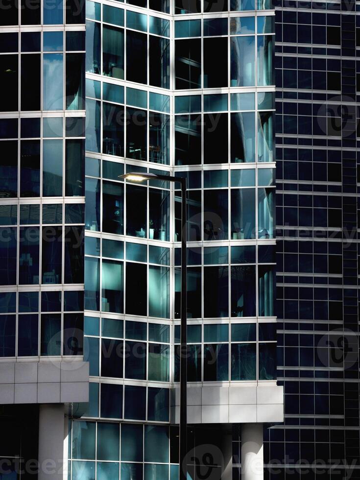 Abstract fragment of modern architecture, walls made of glass photo