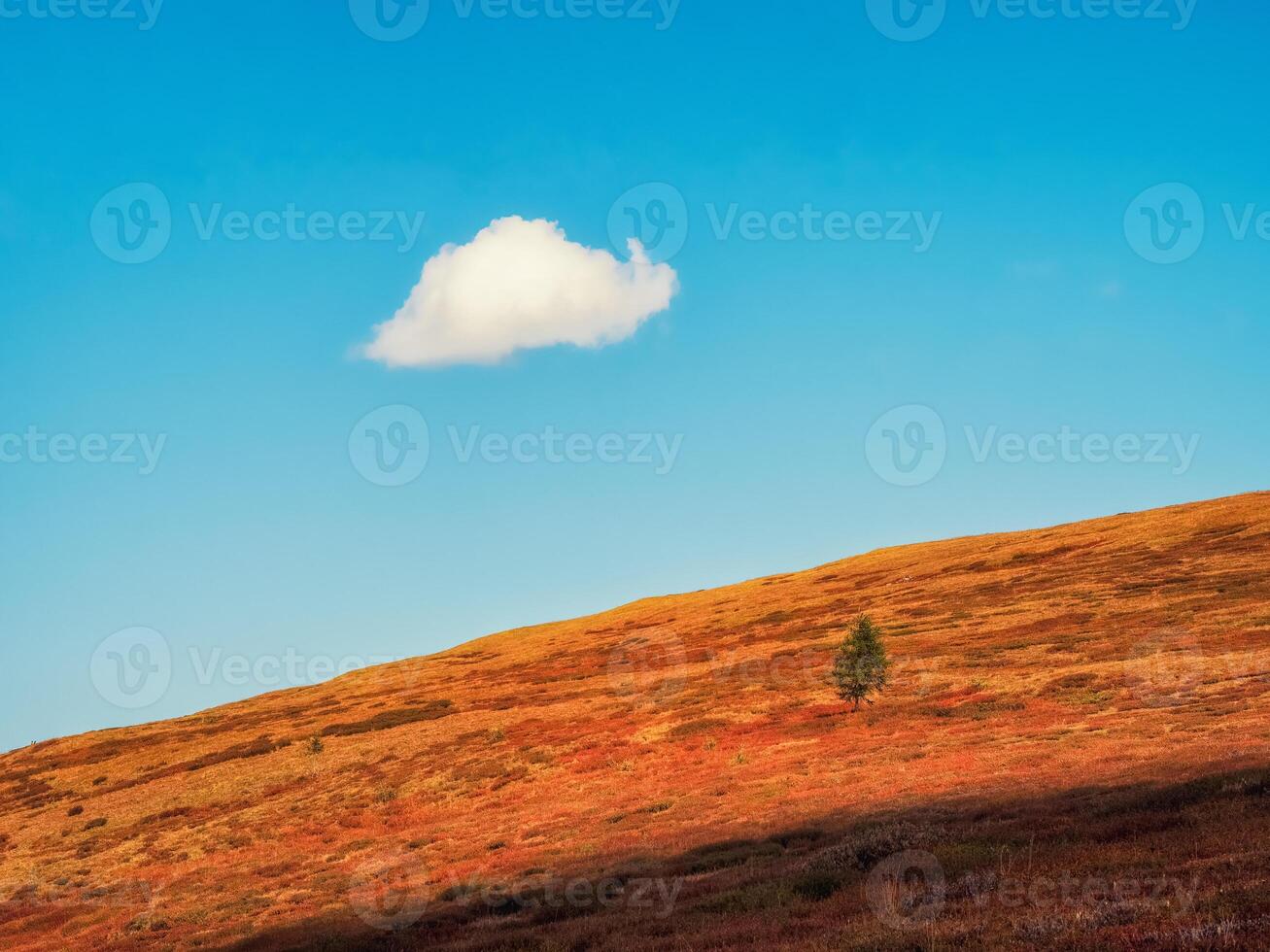 landscape with mountain silhouette under blue sky with alone big cloud. Autumn slope mountain and light sky. Minimal nature background with silhouette of mountain under blue sky. photo
