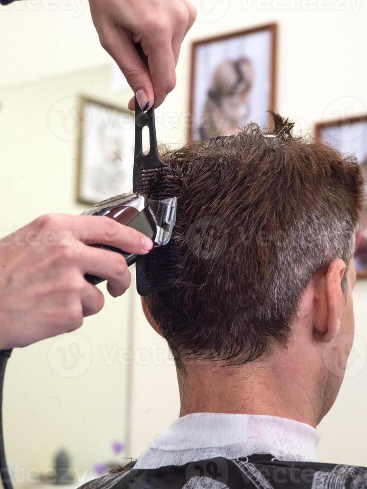 Men's haircut machine. Men's hair with the help of clippers. photo