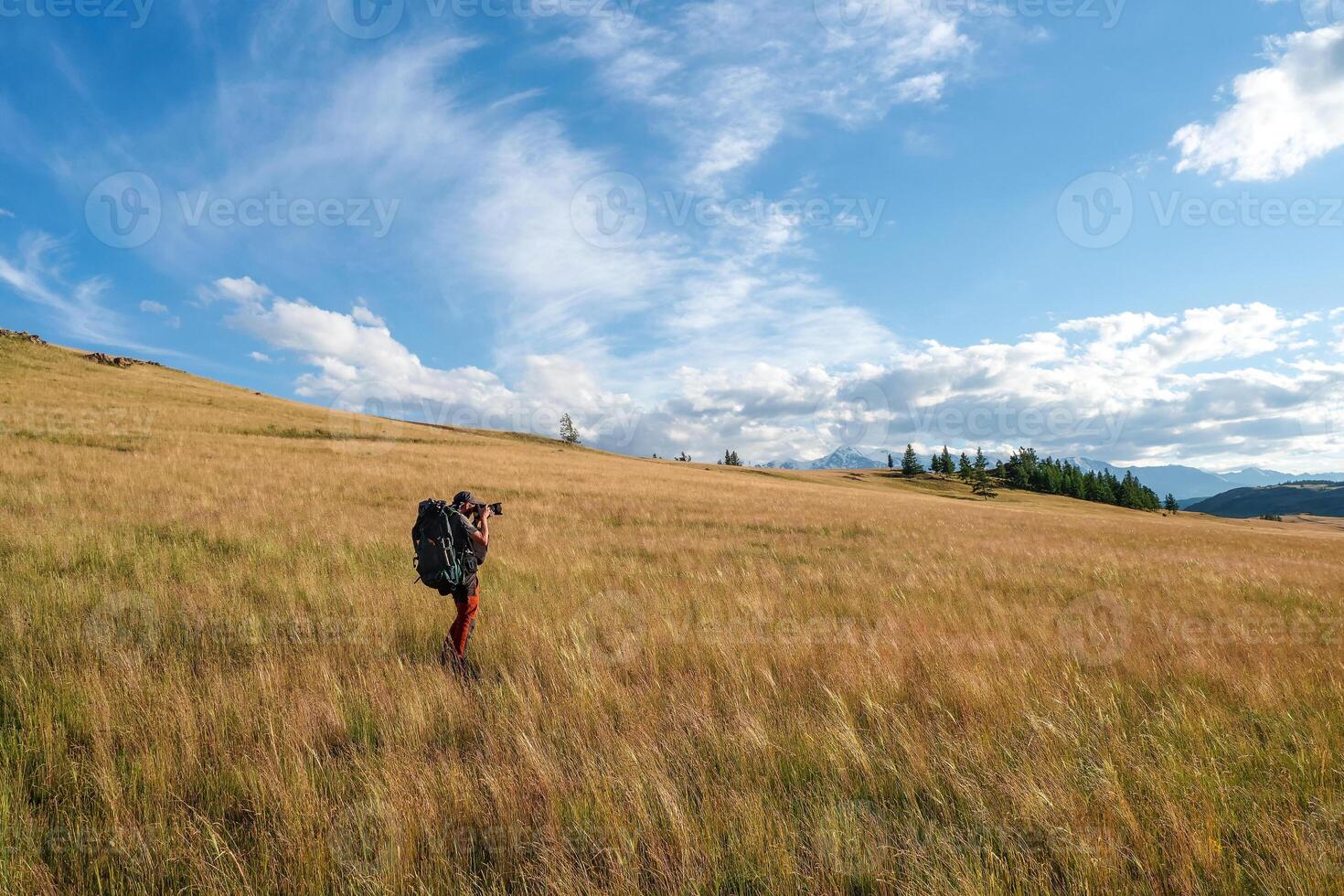 Travel photographer take a picture of Alpine highlands. Solo trekking. Travel freelancer blogger lifestyle, concept adventure voyage outdoor. photo