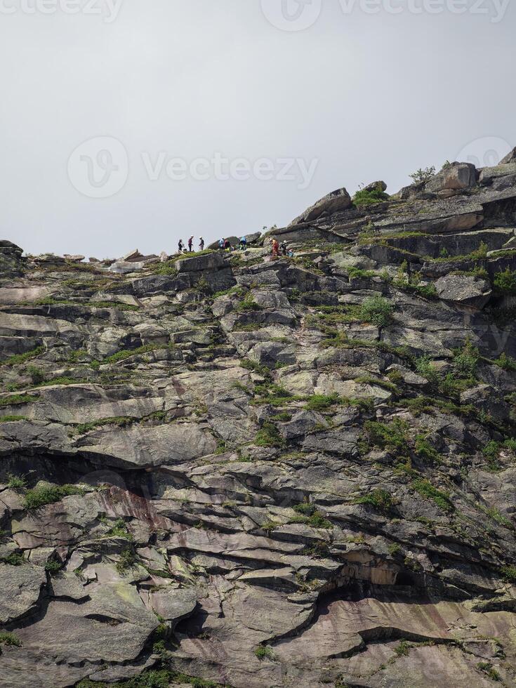A group of climbers on a cliff. photo