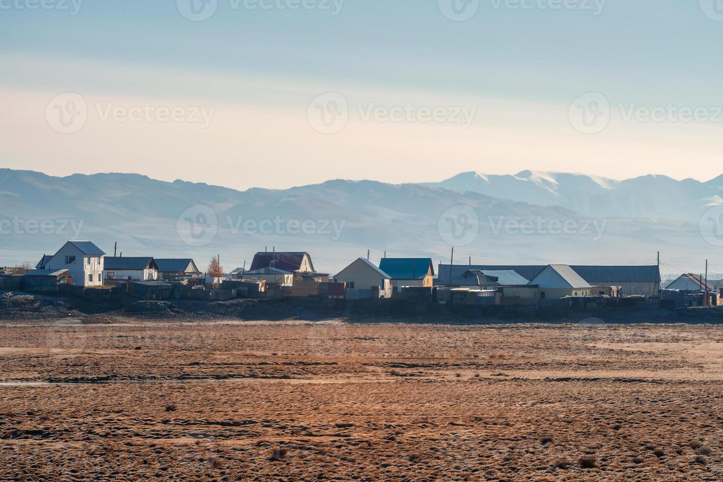 Golden sunny autumn landscape on a foggy morning in the village photo