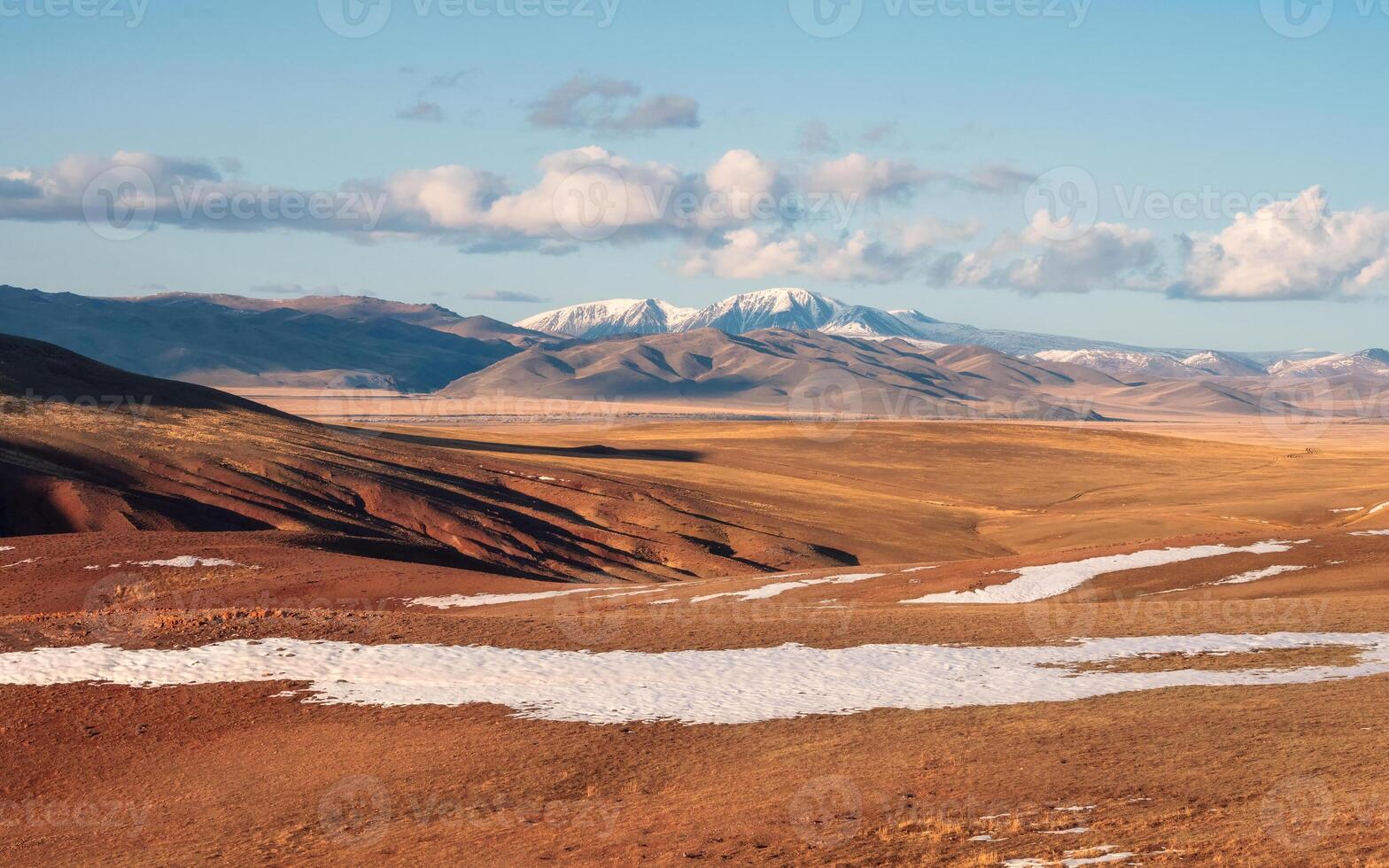 snow-capped mountain peaks and golden autumn steppe photo