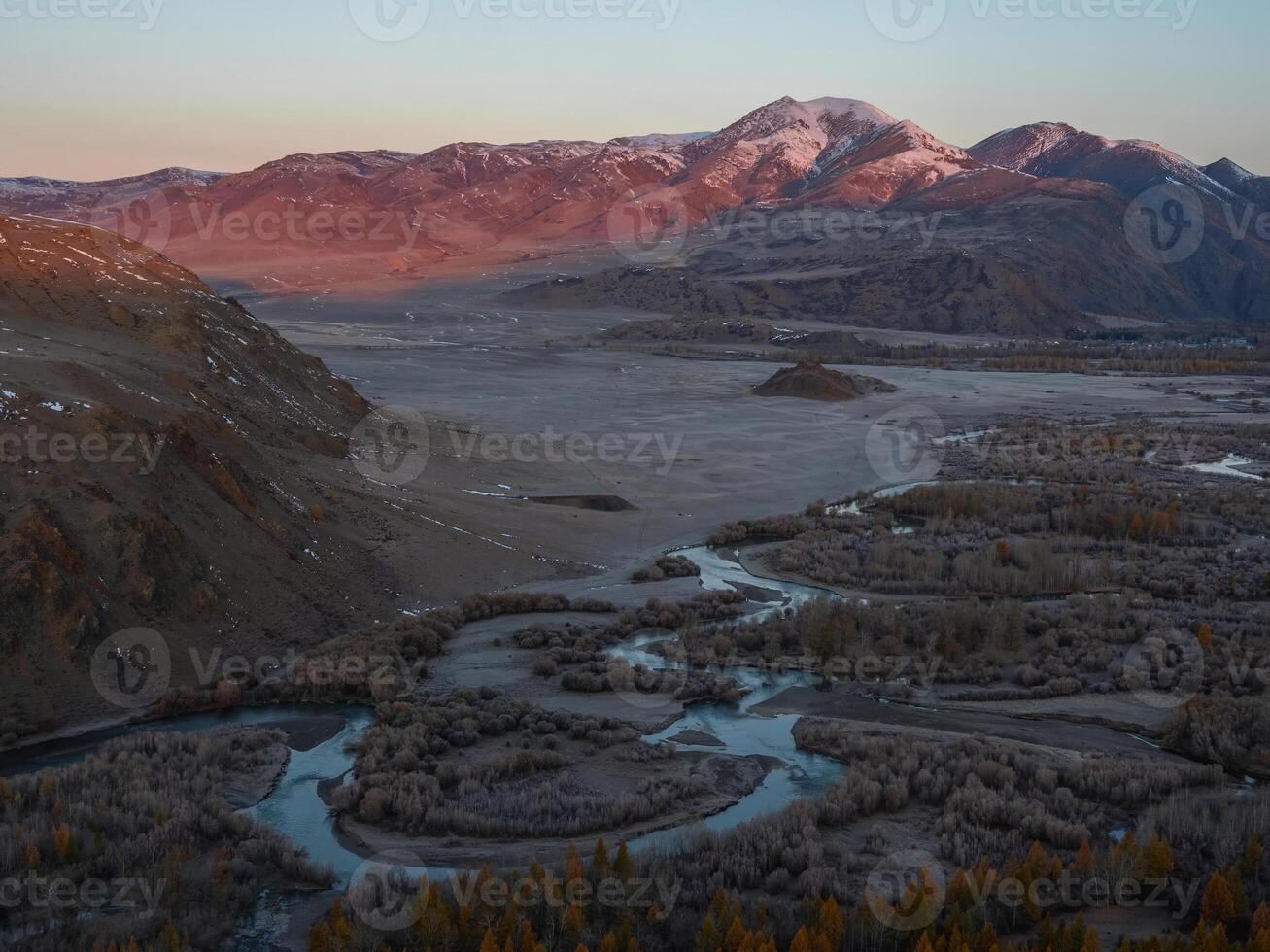 Extraterrestrial landscape on a river bend in the mountains after sunset photo