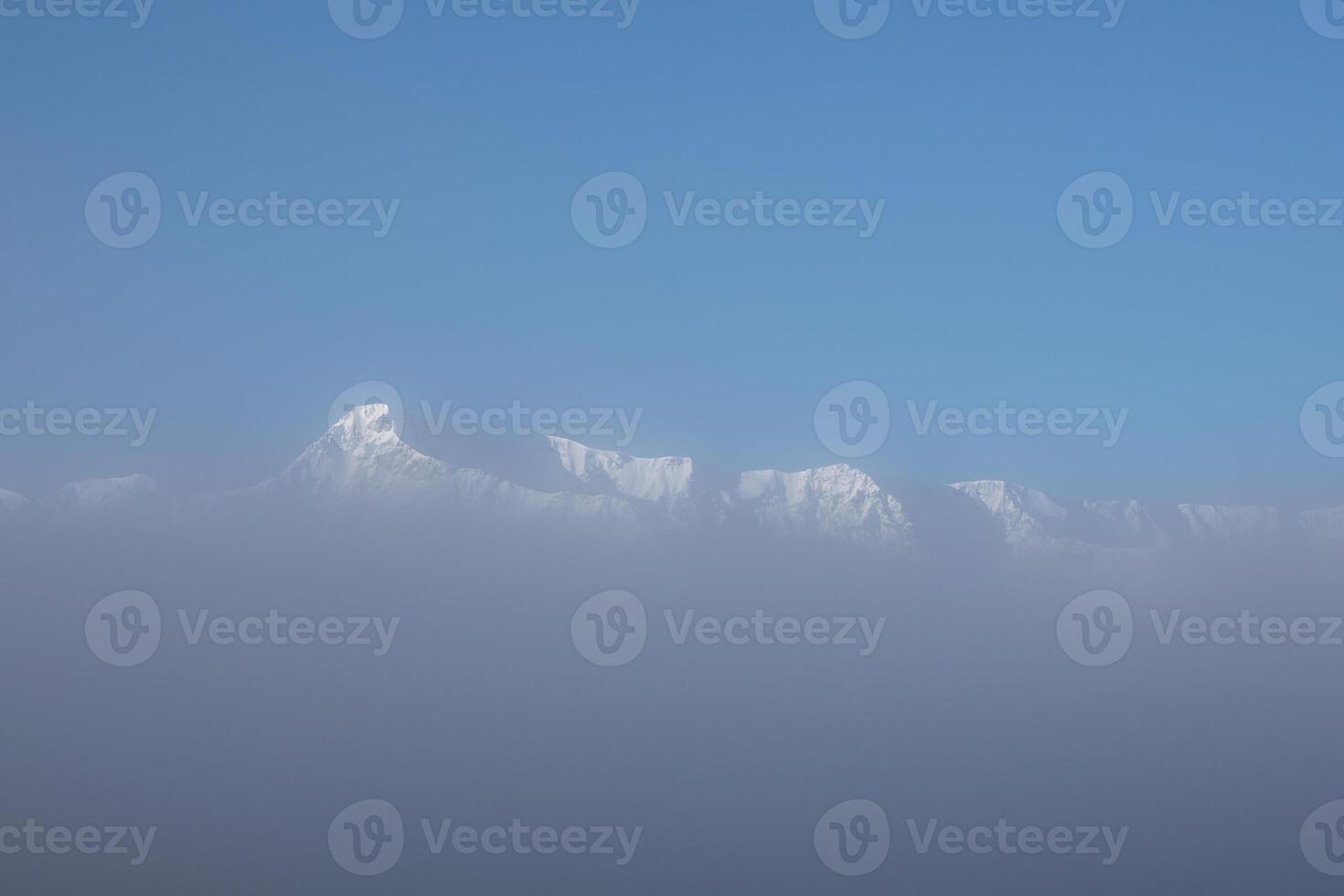 Mountain peaks in the clouds. photo