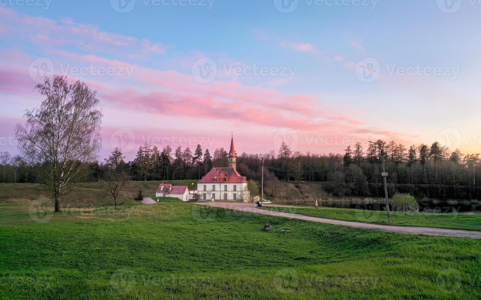 Wonderful evening sunny landscape. Incredible majestic Priory Palace in Gatchina. photo