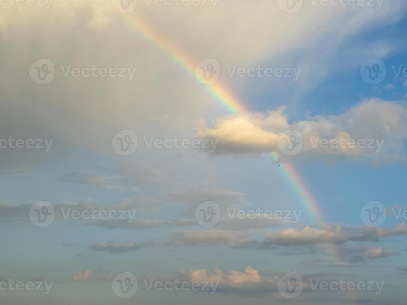 Beautiful rainbow in the sky over clouds. photo