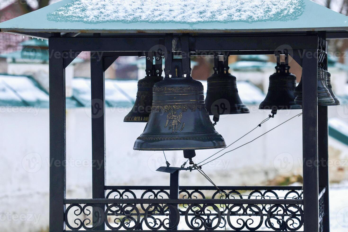 Church bells hang in a row, the bells are ringing. photo