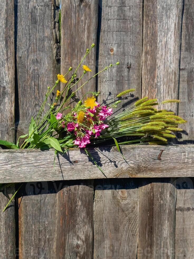 Bouquet with sunflowers in a rustic style, wooden rustic fence photo