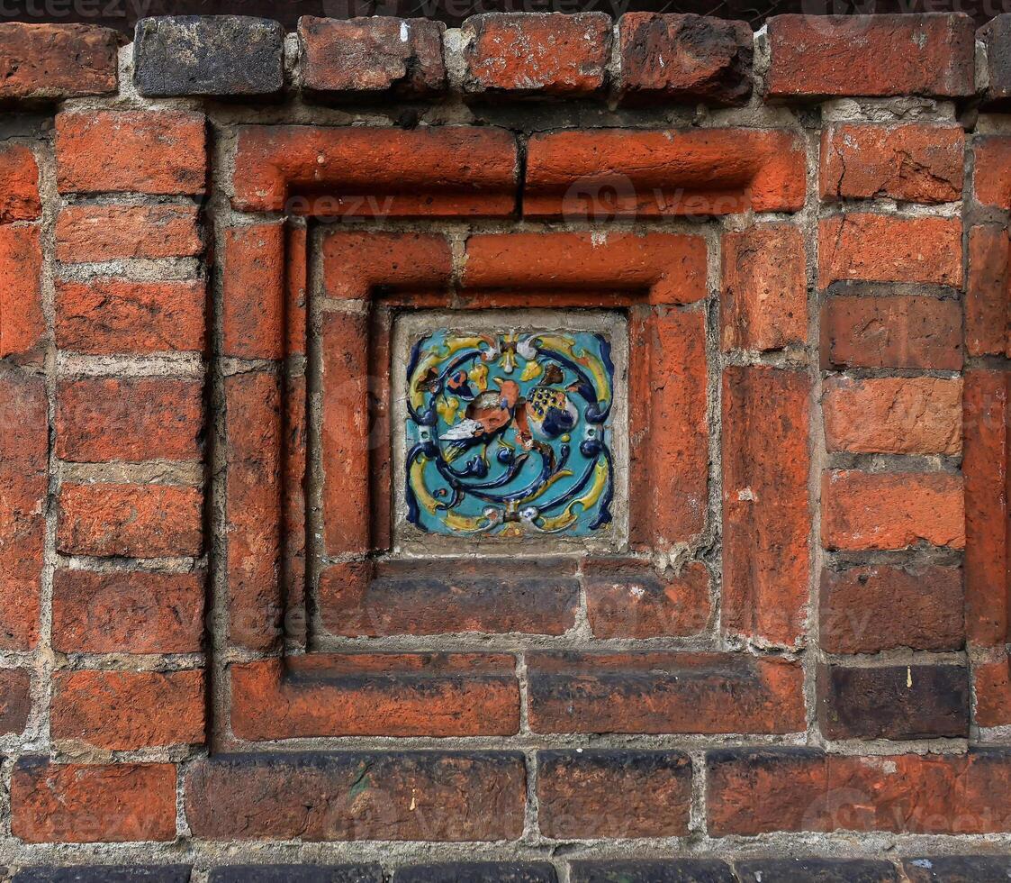 Old decorative glazed ceramic picture ceramic ornament. photo