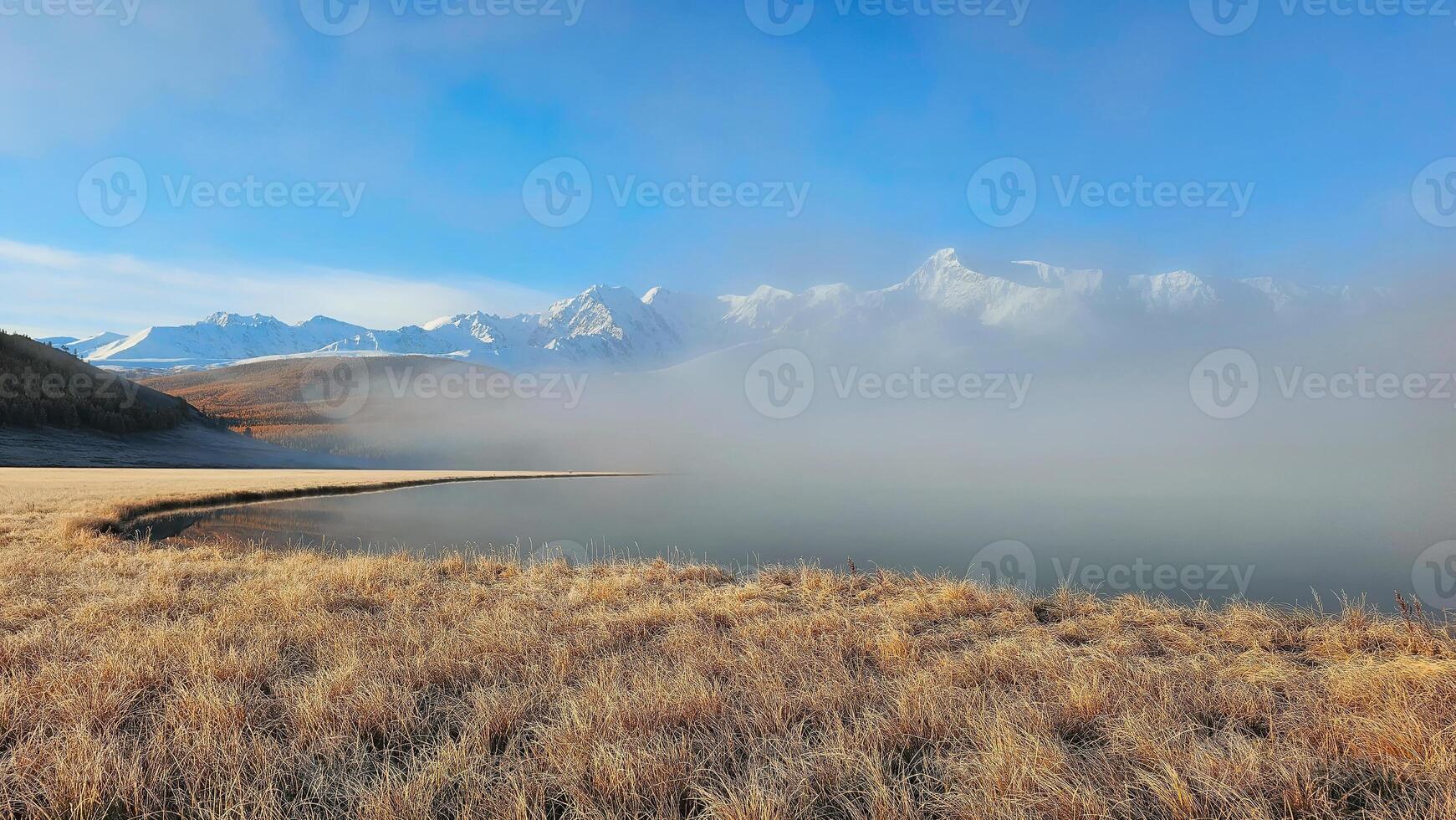 Panoramic open autumn mountain field in the sunny fog looking empty dismal depressing desolate stark grim dramatic bright drab dim. photo