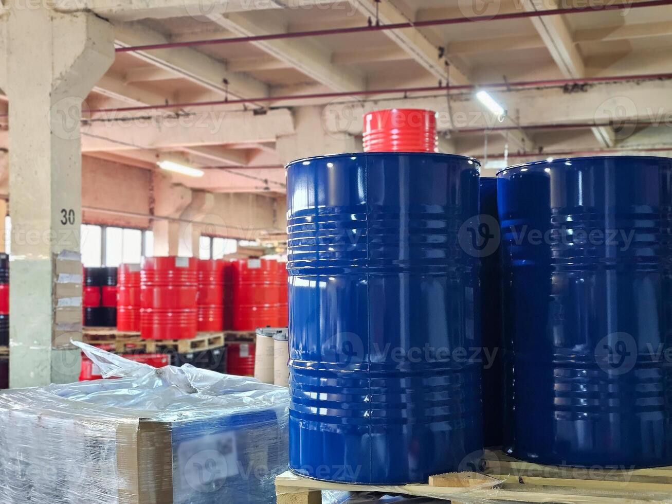 Metal blue and red barrel in the warehouse photo