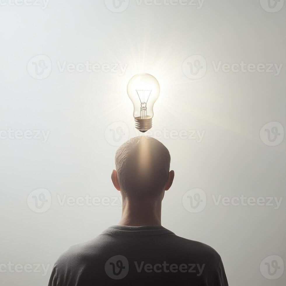 Man with light bulb over head symbolizes new ideas and innovation in a creative concept photo