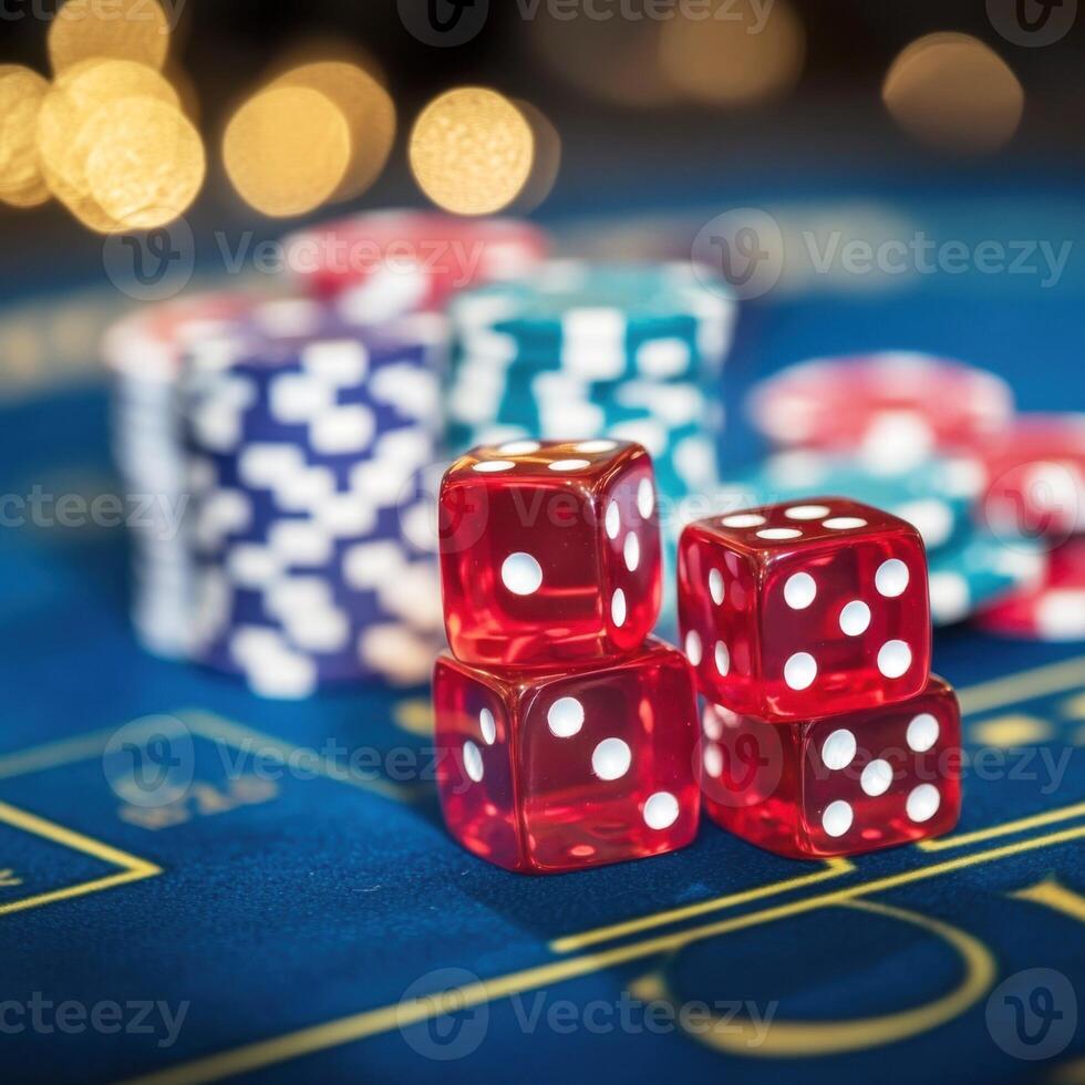 Red dice and colorful poker chips on a blue casino table during an evening game night photo