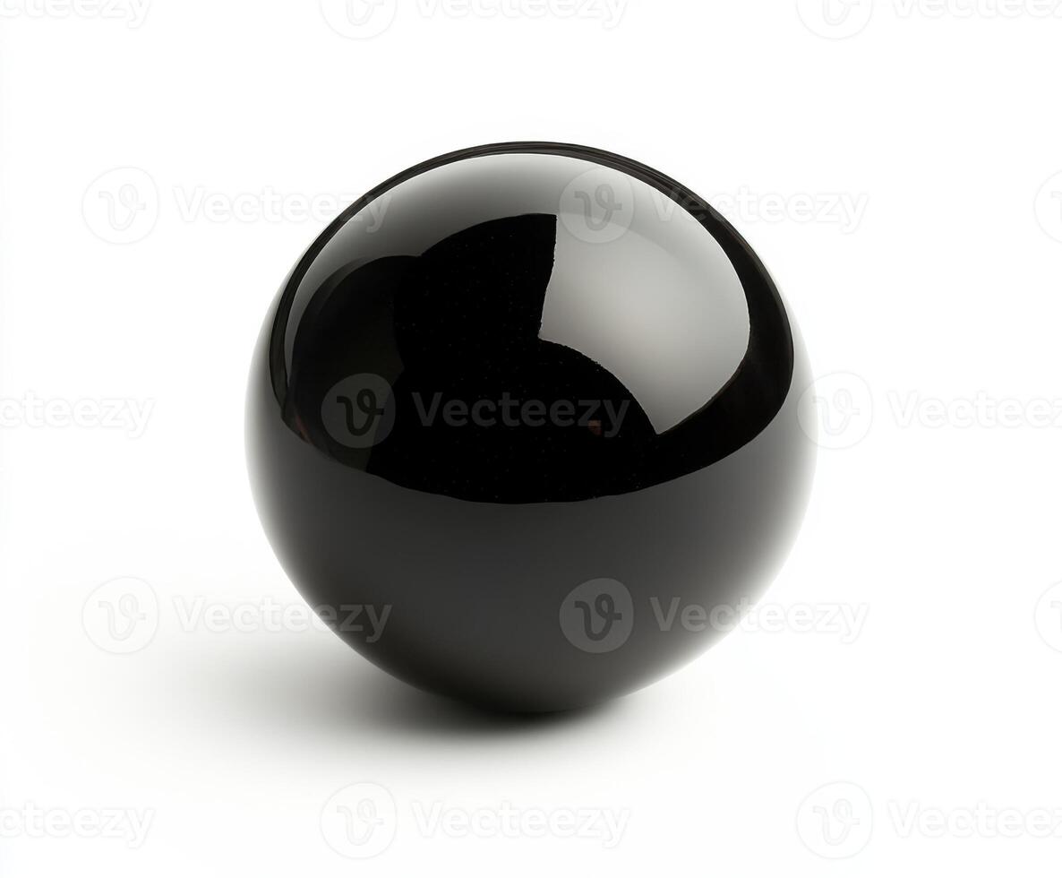 Smooth black billiard sphere sits on a white surface reflecting light in a minimalist setting photo
