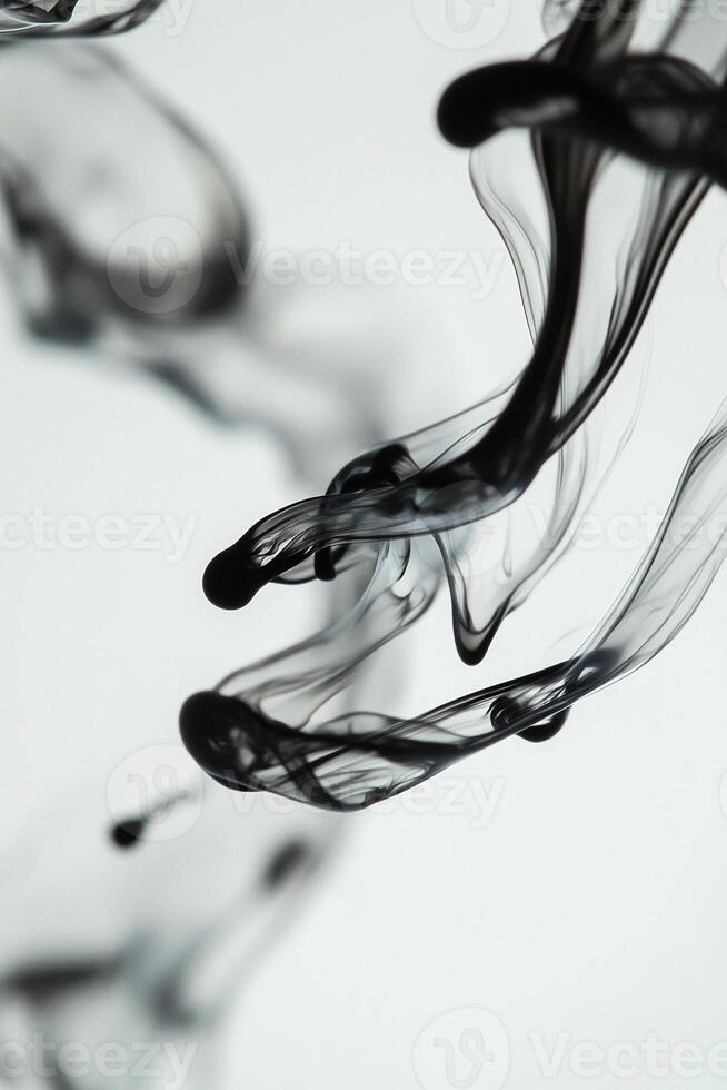 Macro photography of a drop of ink dispersing in water creating fluid shapes and abstract forms with intricate swirls and patterns - Variant 29 photo