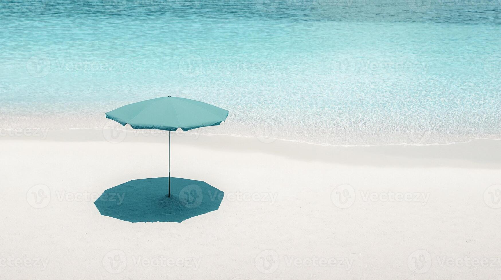 Minimalist beach umbrella casting shadow on serene sandy shore with calm blue sea and clear sky photo