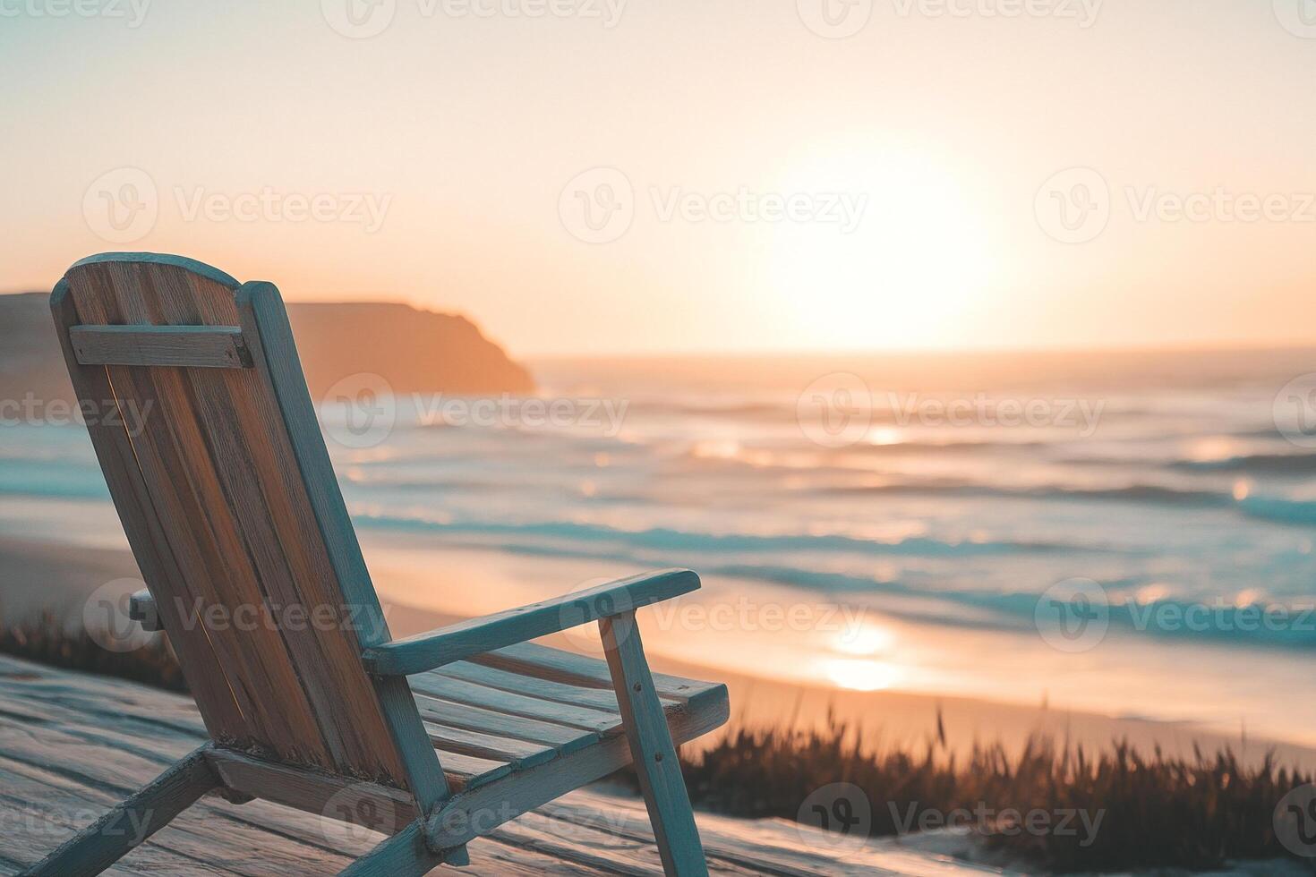Wooden deck chair facing serene ocean waves at golden hour relaxing coastal scenery and beach tranquility photo