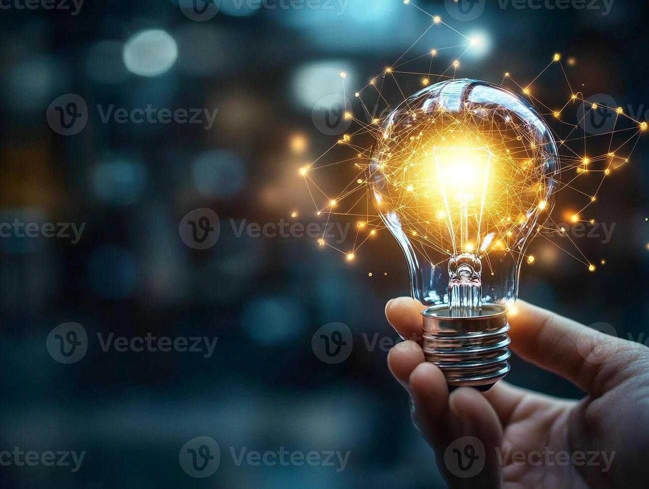 Glowing lightbulb held in hand with intricate golden light trails representing ideas innovation and creativity photo
