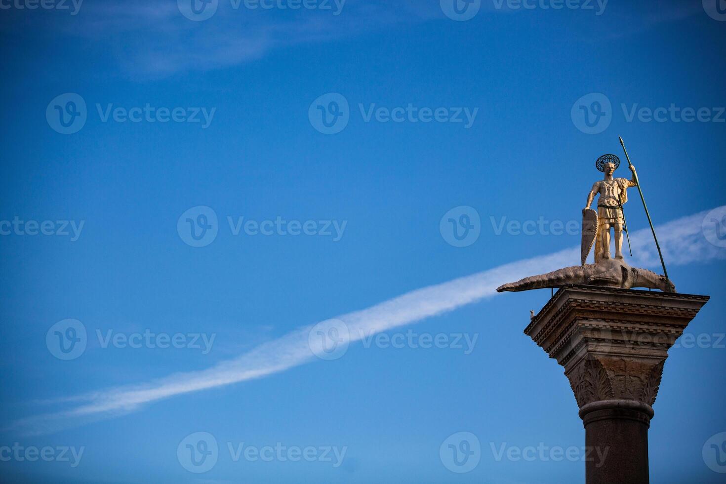 A statue of a man on top of a pillar photo