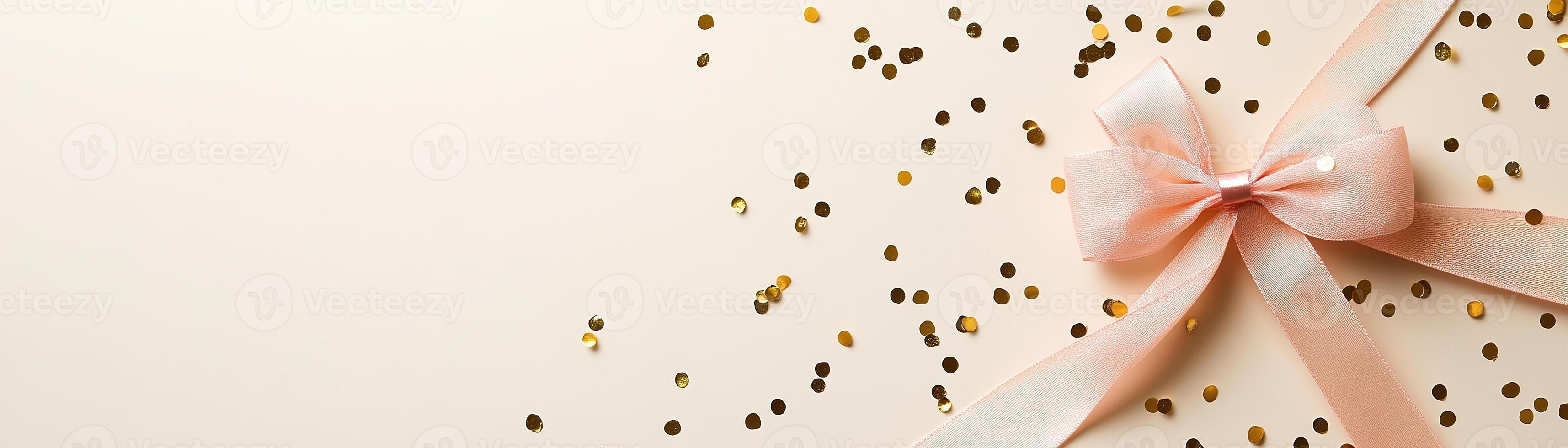 This festive background features scattered gold confetti and a delightful pink ribbon bow, set against a smooth light beige surface, perfect for celebrations and special occasions photo