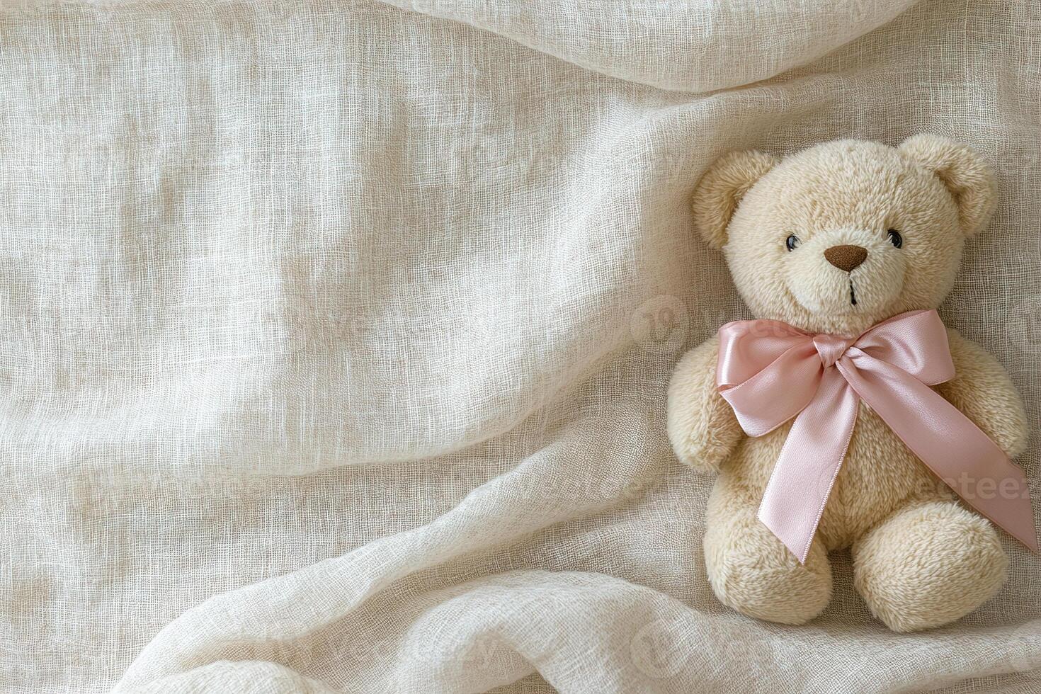 A soft pastel linen fabric showcases a charming teddy bear adorned with a pink ribbon bow, evoking a sense of comfort and coziness in a serene setting perfect for adding warmth photo