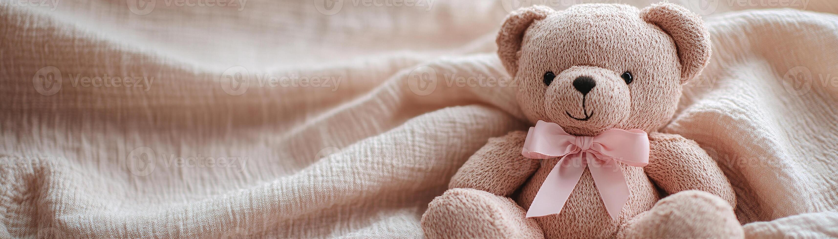 A charming teddy bear with a pink ribbon bow rests on soft pastel linen fabric, inviting a sense of calm and coziness with ample space for creative text overlays photo