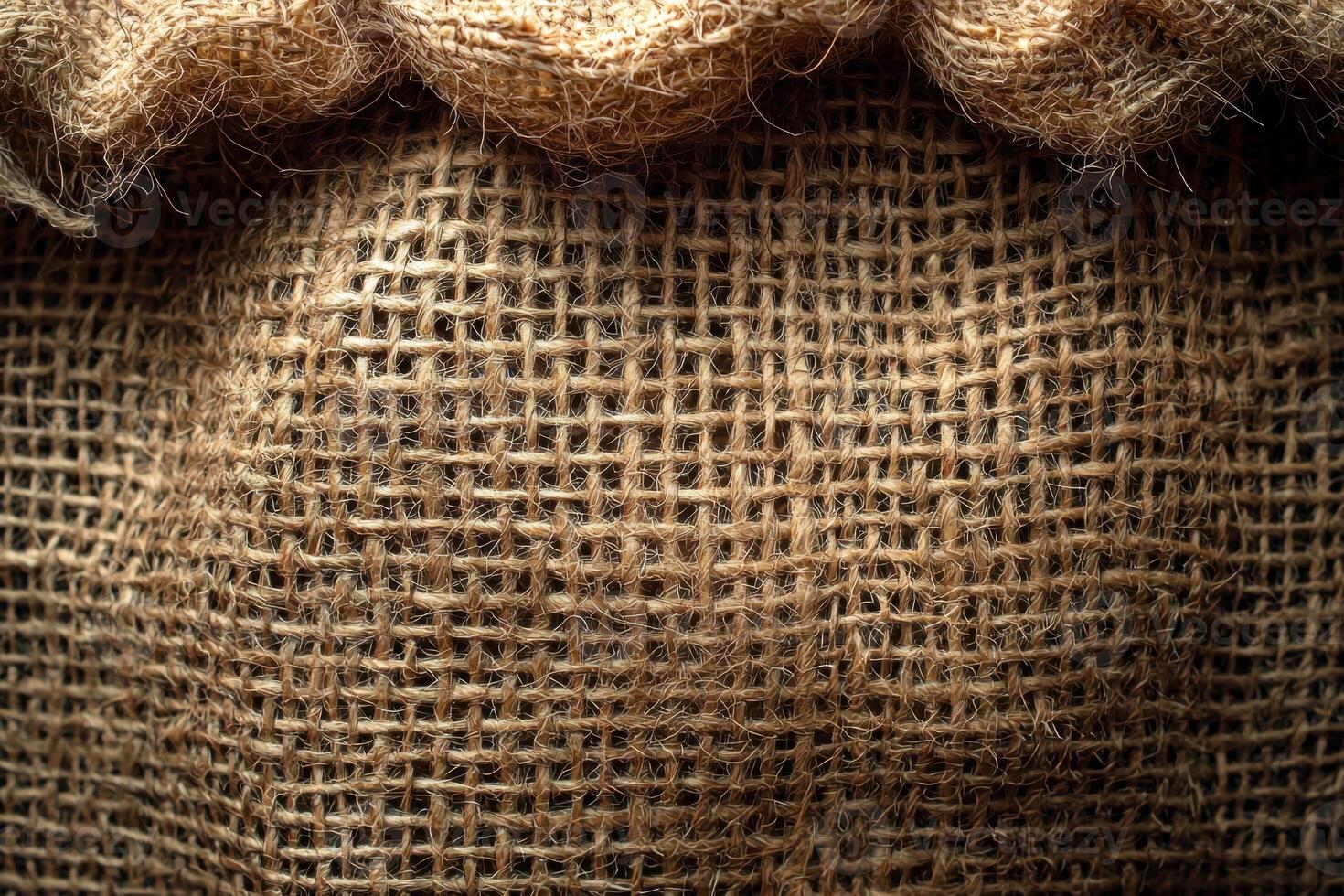 Details of rough burlap fabric are highlighted featuring coarse weave and uneven threads create natural and rustic look. earthy beige tones enhance its organic quality photo